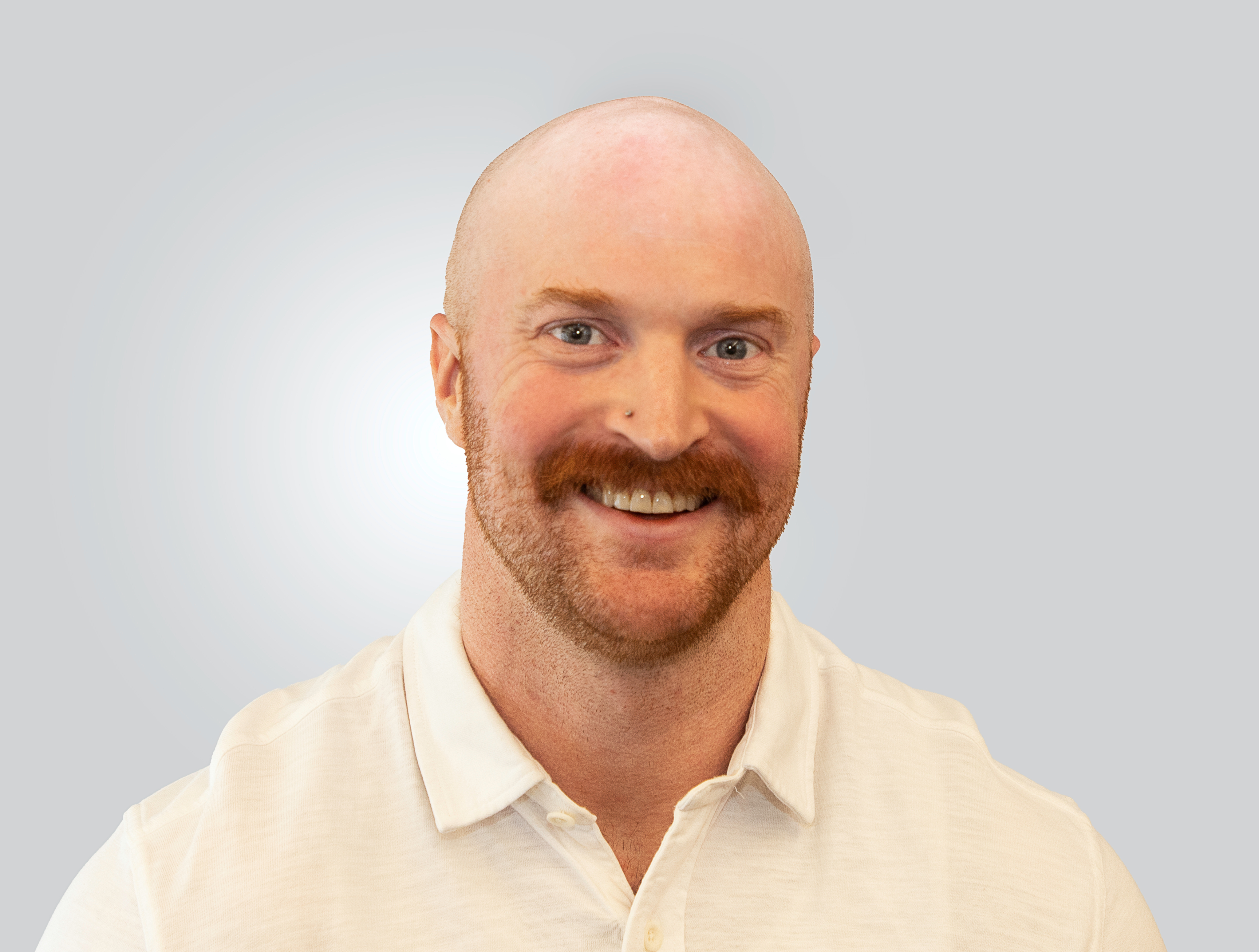 Portrait of a man with glasses wearing a gray shirt.